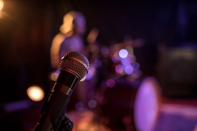 Close up of microphone in illuminated nightclub