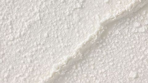 Granular white powder texture with sparkling crystals