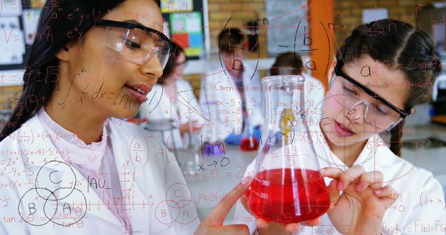 Two female students of diverse backgrounds conducting a chemistry experiment in a lab. They are wearing white lab coats and safety goggles, analyzing red liquid in a flask. The image is overlaid with mathematical and chemical formulas, enhancing the scientific atmosphere. This can be used for educational materials, STEM promotion, diversity in education, or science-themed campaigns.