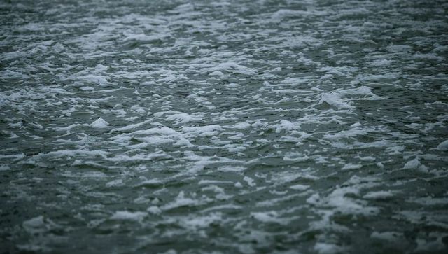Moody rippling ocean surface with foam and whitecaps overcast seascape texture