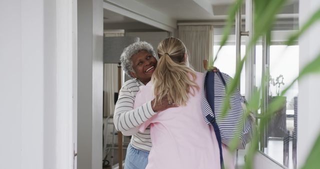 Happy Senior Woman Hugging Adult Daughter in Entryway - Download Free Stock Images Pikwizard.com