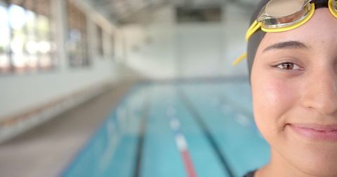 Female Athlete Preparing for Swim in Indoor Pool