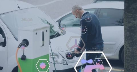 Man plugging electric hatchback into street charger with augmented data overlay