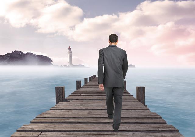 Businessman in a suit walking on a wooden pier towards a distant lighthouse. The scene is foggy and serene, giving a sense of calm, determination, and focus on reaching a goal. Suitable for business themes, concepts of leadership, strategy, and career development.