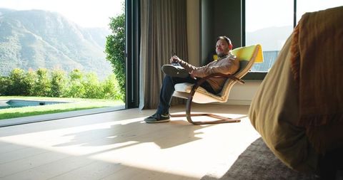 Relaxed Man in Modern Home with Scenic Mountain View