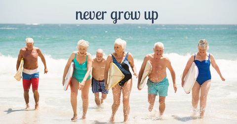 Joyful seniors surfing and enjoying life at beach