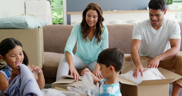 Young Hispanic Family Unpacking Boxes in New Home Together - Download Free Stock Images Pikwizard.com