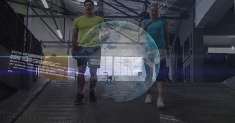 Fitness duo walking on warehouse ramp with earth hologram and binary data overlay