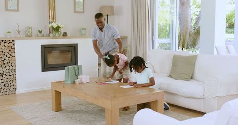 Children engaged in creative crayon drawing in cozy living room