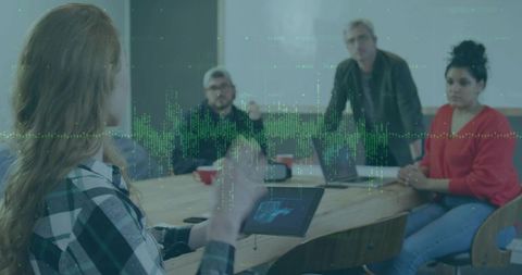 Woman Presenting Technical Schematic on Tablet to Team in Meeting Room with Green Data Wave Overlay