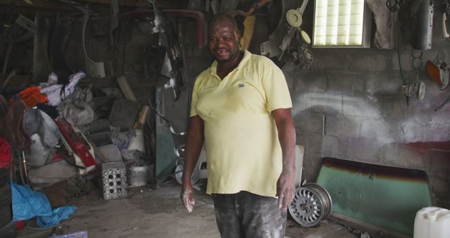 Smiling Mechanic in Garage with Auto Parts and Tools - Download Free Stock Images Pikwizard.com