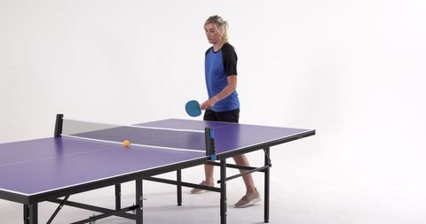 Female Athlete Playing Table Tennis in Minimalist Studio