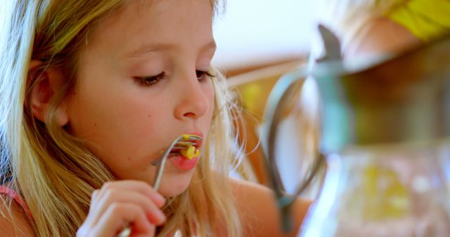 Young Girl Eating Pasta at Home Dining Table - Download Free Stock Images Pikwizard.com