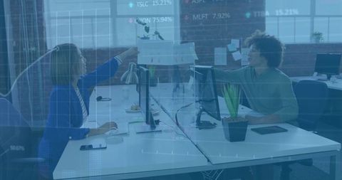 Team collaboration behind trendy glass partition in tech workspace