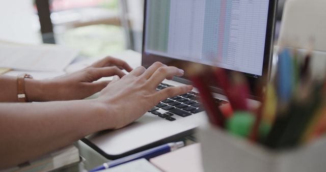 Close-Up of Hands Typing on Laptop Using Spreadsheets at Office Desk - Download Free Stock Images Pikwizard.com