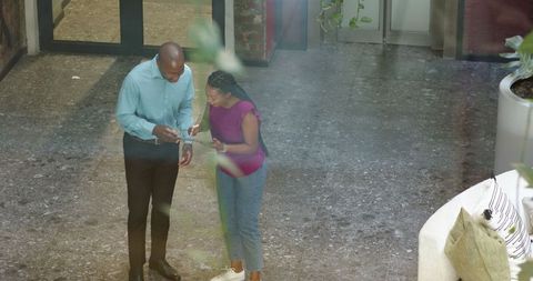 Diverse Colleagues Collaborating with Tablet in Modern Office Space