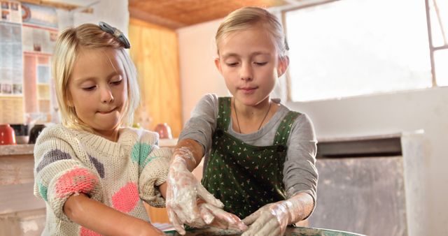 Two Young Girls Enjoying Pottery Crafting Together in Studio - Download Free Stock Images Pikwizard.com