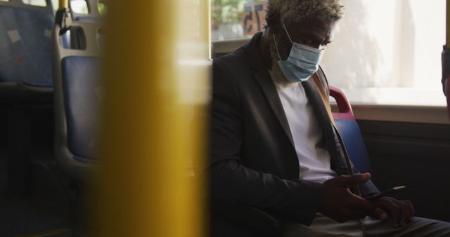 Senior Man Wearing Mask Using Smartphone on Public Bus - Download Free Stock Images Pikwizard.com