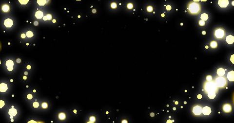 Golden twinkling lights on dark background creating festive atmosphere