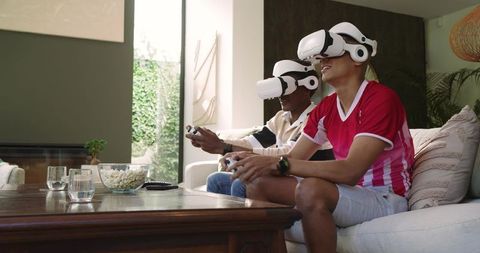 Friends Enjoying Virtual Reality Experience on Sofa at Home