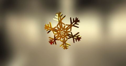 Golden snowflake on subtle gray background for elegant decorations