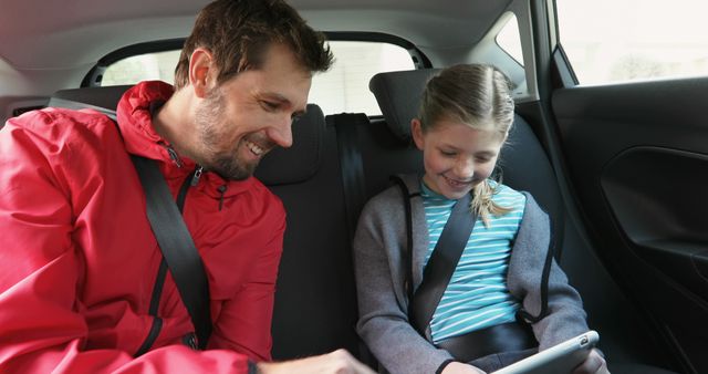 Father and Daughter Riding in Car Backseat Enjoying Tablet - Download Free Stock Images Pikwizard.com