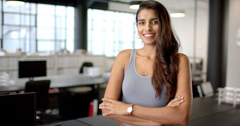 Confident Businesswoman Standing Proudly in Modern Office