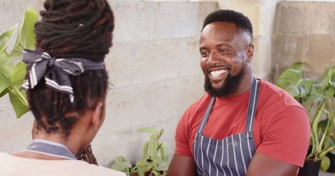 Coworkers Collaborating in Landscape Nursery Smiling