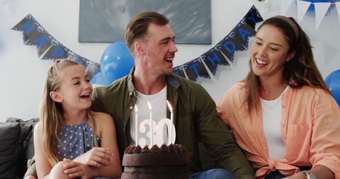 Joyful Family Birthday Celebration with Cake and Candles