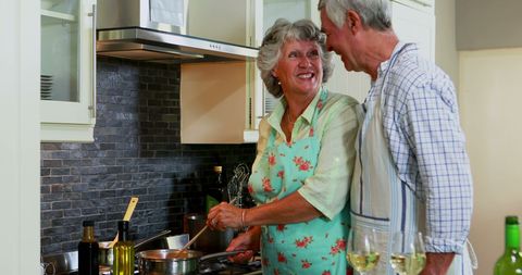 Senior Couple Enjoying Cooking Together in Cozy Home Kitchen