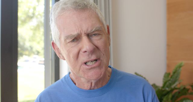 Senior Man Shouting Indoors with Serious Expression - Download Free Stock Images Pikwizard.com