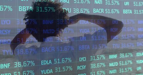 Contemplative Man at Beach Amidst Floating Financial Data