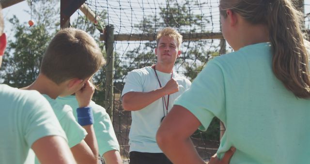 Young Coach Motivating Kids During Outdoor Team Practice - Download Free Stock Images Pikwizard.com