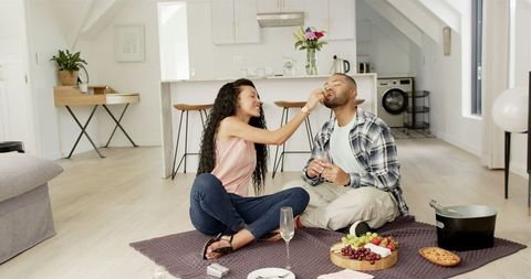 Couple Celebrating Anniversary Enjoying Food and Wine at Home