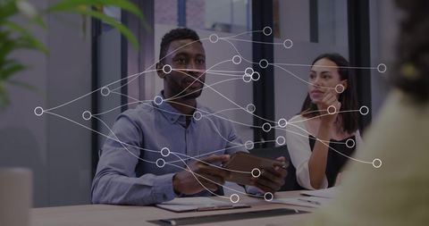 Diverse team engaging with digital network visualization