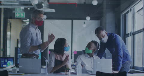 Diverse Business Team Analyzing Data with Face Masks