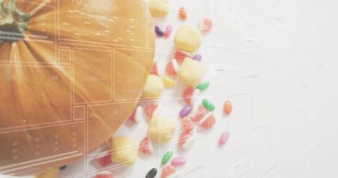 Showing pumpkin with colorful candy scatter and translucent calendar grid overlay