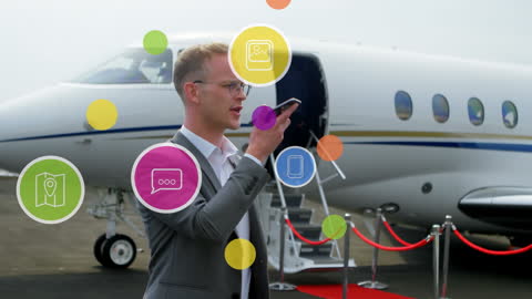 Businessman Communicates Digitally Near Private Jet