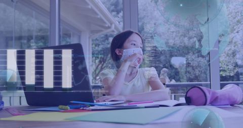 Young Girl in Mask Using Laptop with Digital Data Overlay