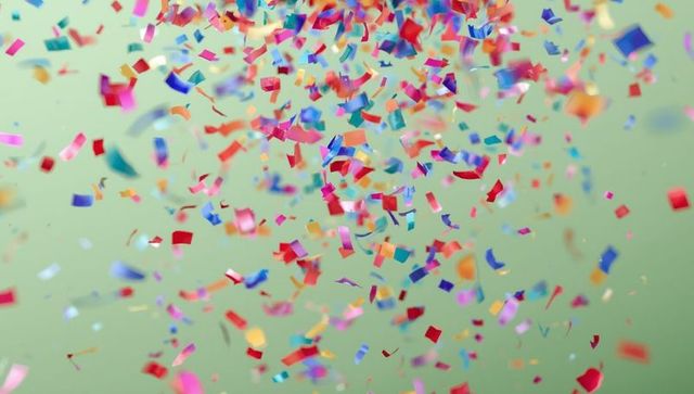 Vibrant Multicolored Confetti on Pale Green Backdrop