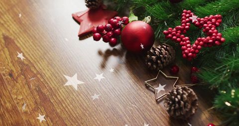 Christmas Decor with Pinecones and Red Ornaments on Wooden Table