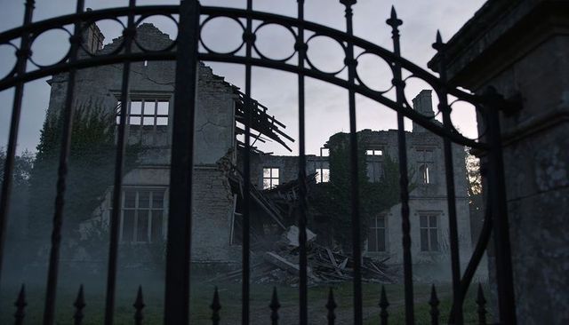 Crumbling Stone Manor behind Wrought-Iron Gate at Foggy Dusk, Ivy-Covered Ruins