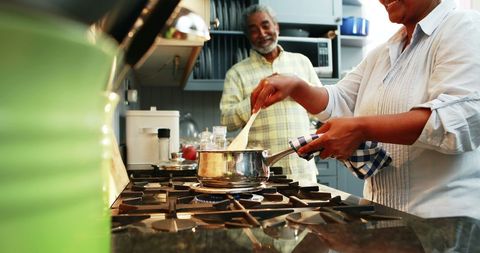 Happy Senior Couple Cooking Together in Their Comfortable Kitchen