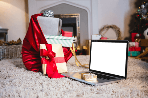 Transparent Christmas Gifts by Fireplace with Laptop