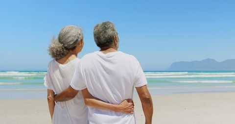 Senior Couple Embracing While Admiring Beach View