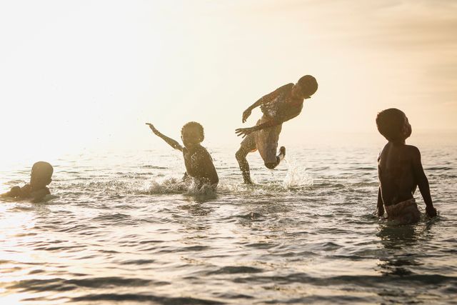 Children Playing in Ocean at Sunset - Download Free Stock Images Pikwizard.com