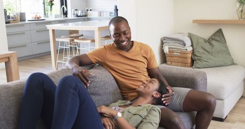 Happy African American Couple Relaxing on Comfortable Sofa at Home
