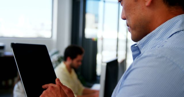 Man Using Digital Tablet in Modern Office Setting - Download Free Stock Images Pikwizard.com