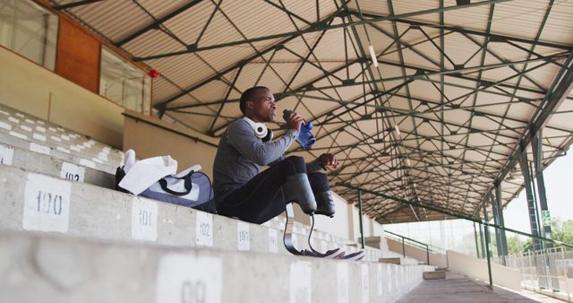 Paralympic athlete preparing for track and field training on empty bleachers - Download Free Stock Images Pikwizard.com