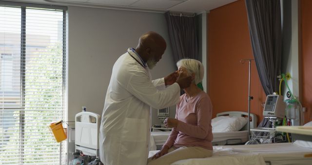 African american male doctor examining senior caucasian female patient at hospital - Download Free Stock Photos Pikwizard.com
